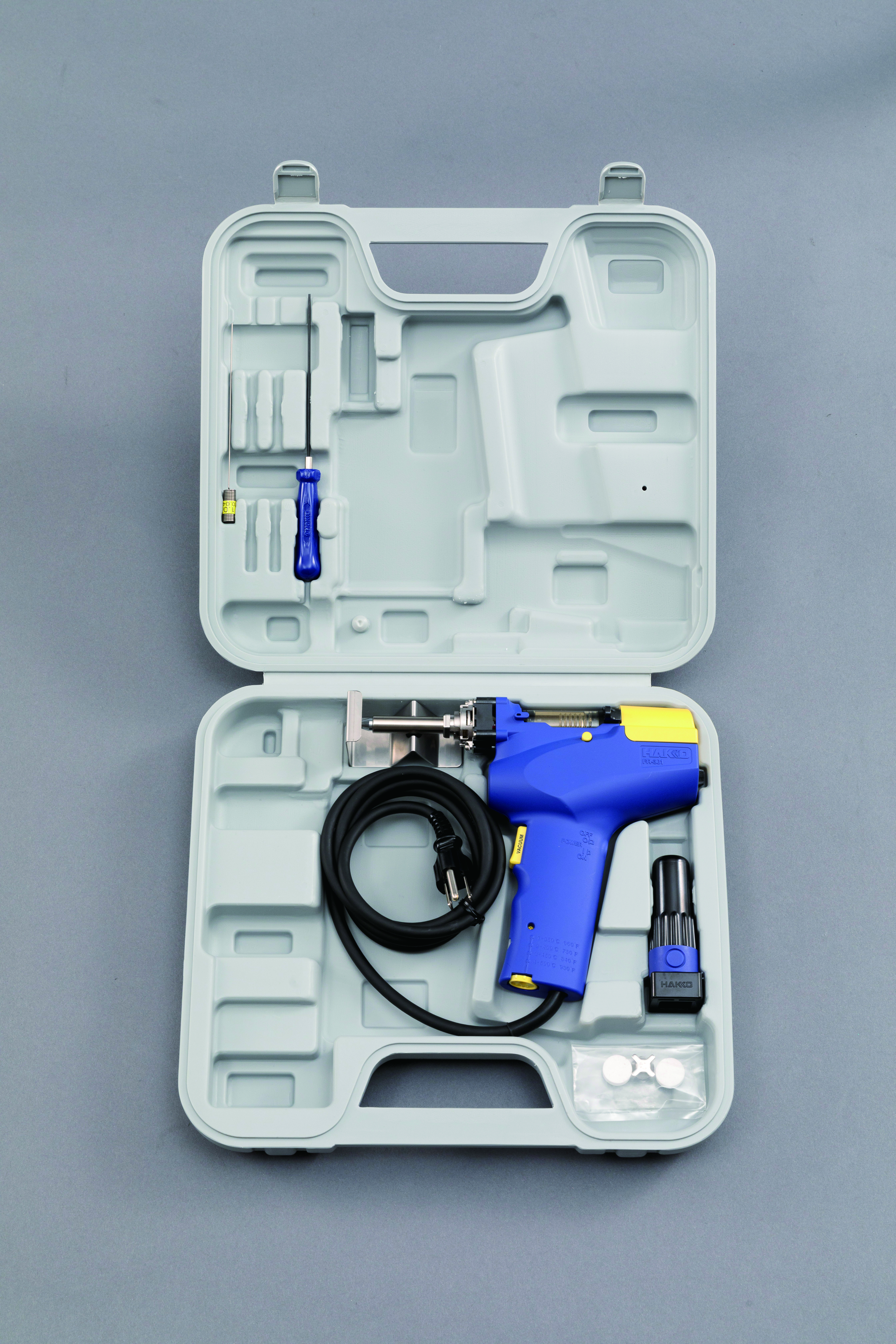 Hakko FR-301 desoldering gun in gray transport case with filter pads and cleaning tools