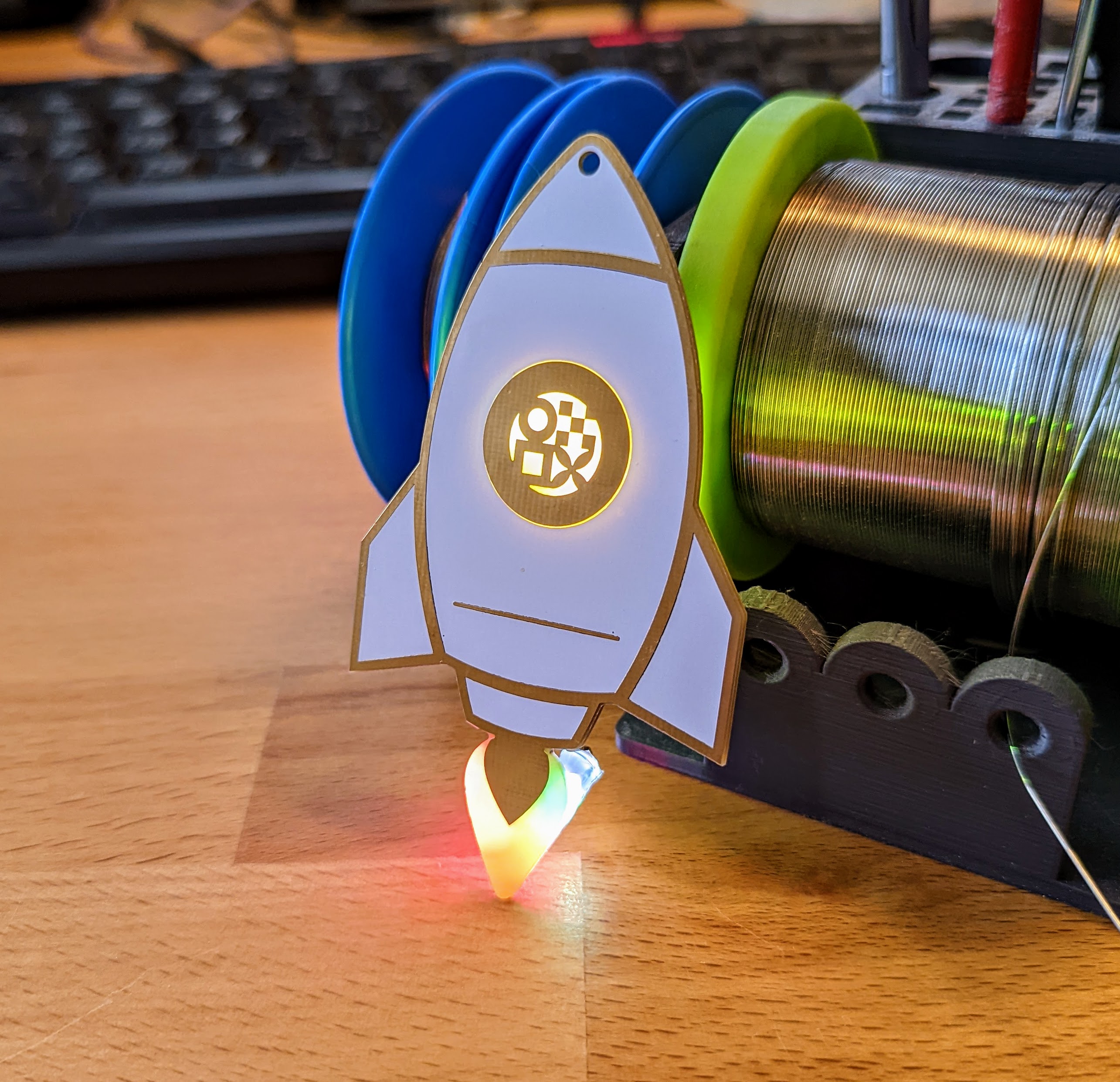 Front view of the completed rocket with active, color-changing LEDs