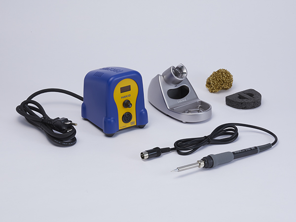Hakko FX-888DX soldering station with soldering iron tool holder and cleaning tools on white background