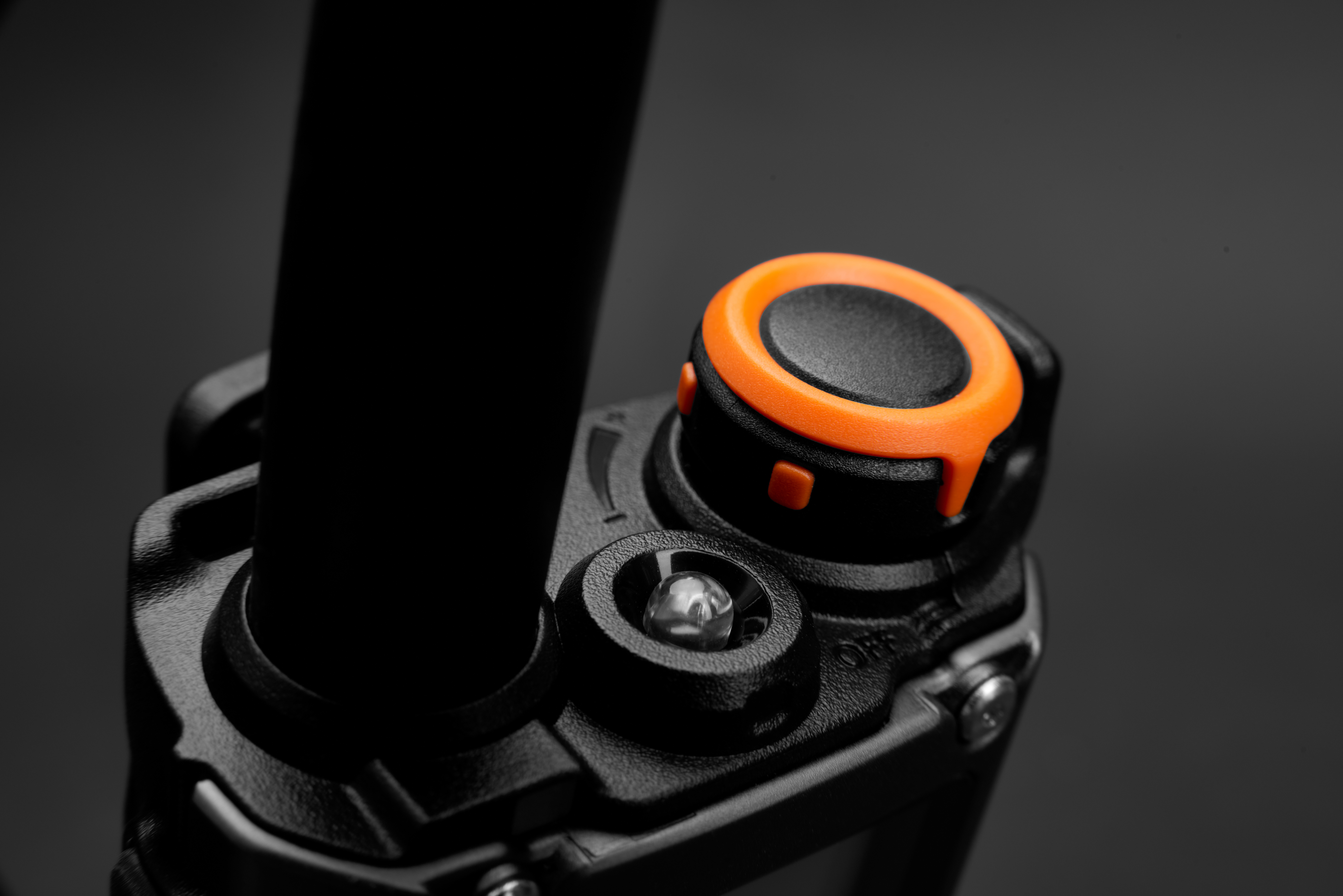 Top view showing antenna connector and rotary knob on a black radio