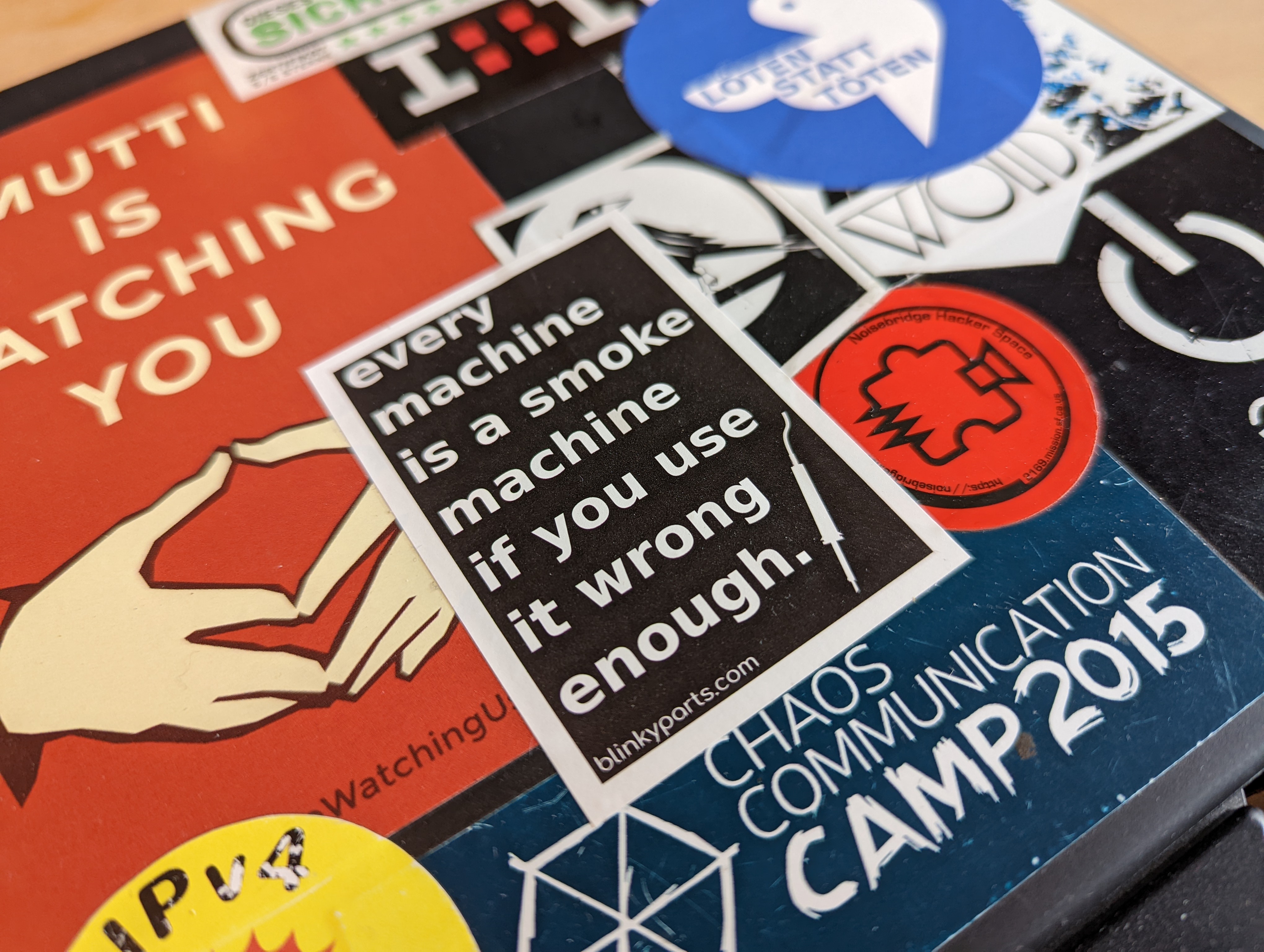 The sticker pasted on a laptop with many other stickers