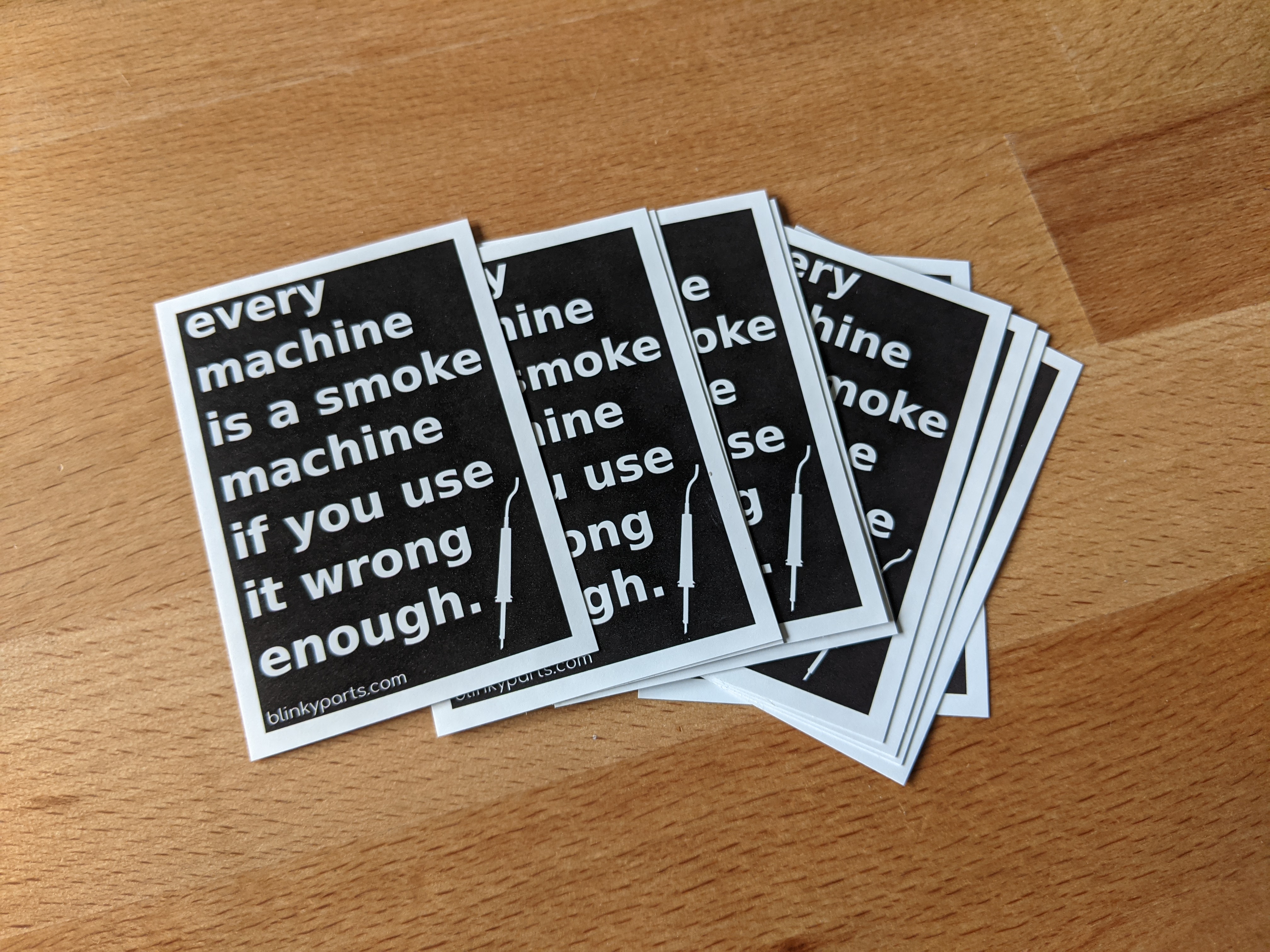 Some of the Smoke Machine stickers are spread out on the table